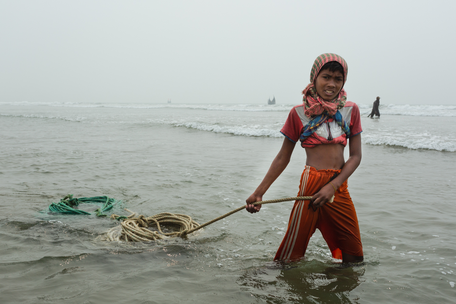 Girl bringing rope back in to shore at Bay of Bengal, Cox’s Bazar Bangladesh