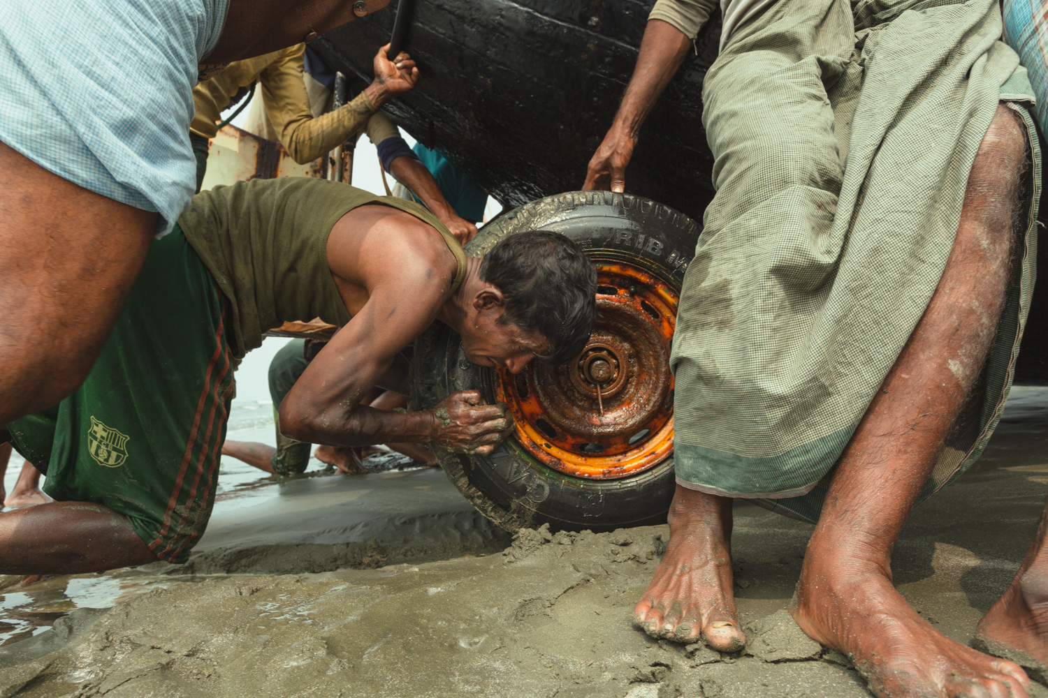 Forcing a bogged boat out of the wet sand and Bay of Bengal, Cox’s Bazar Bangladesh