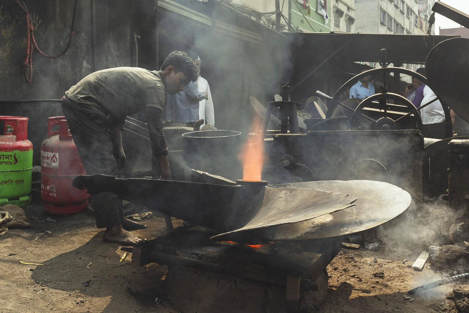 Manipulating metal parts at Dhaka, Bangladesh Shipyard.
