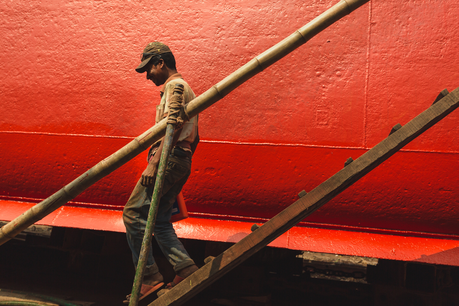 Painter returning to ground after painting vessel at Dhaka, Bangladesh Shipyard.
