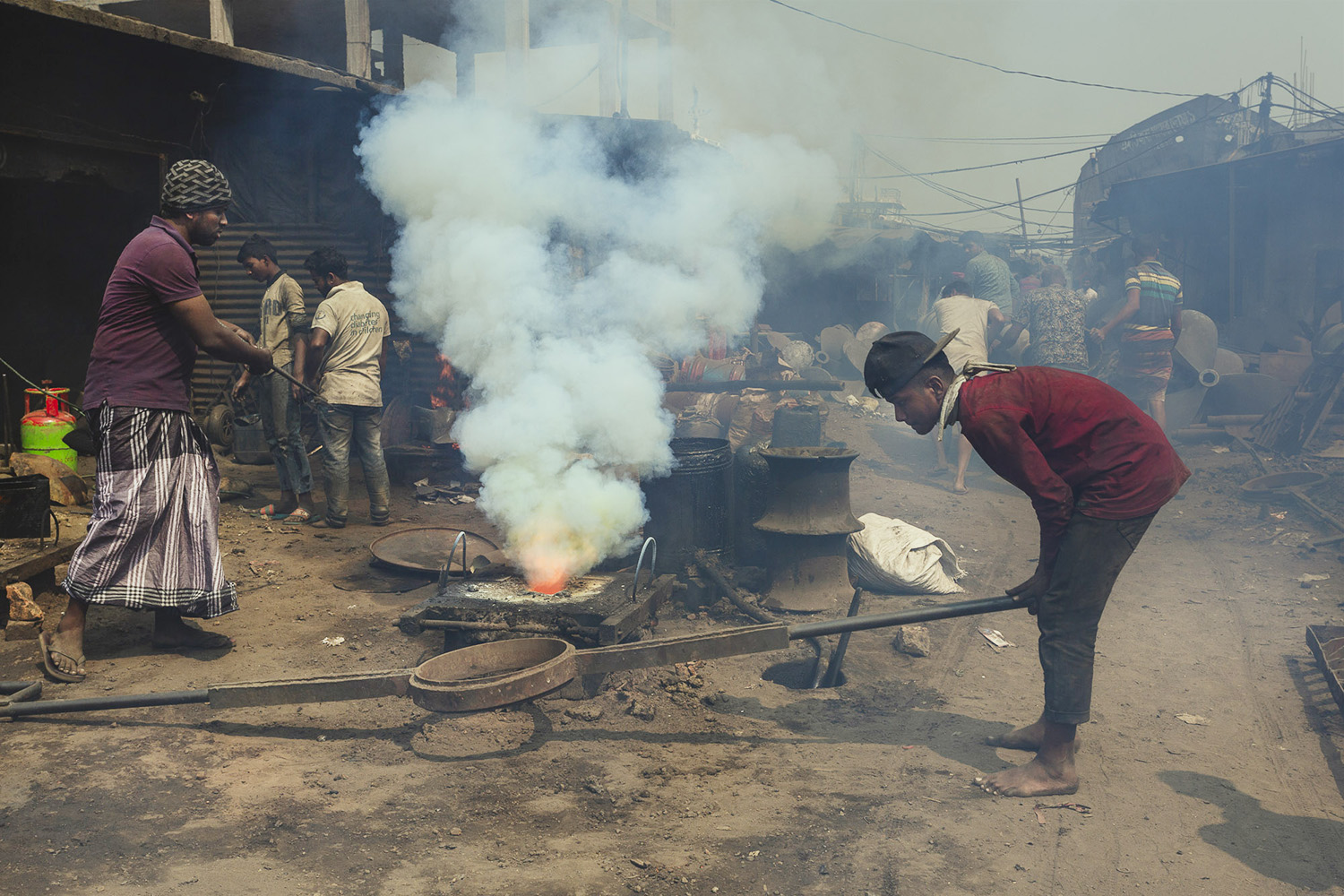 Welding and moulding techniques utilising heat and tools at Dhaka, Bangladesh Shipyard.