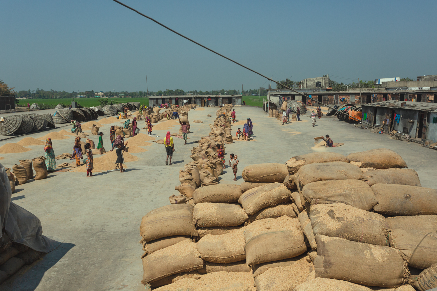 Families and workers gather at Rice Mills in Dhaka, Bangladesh.