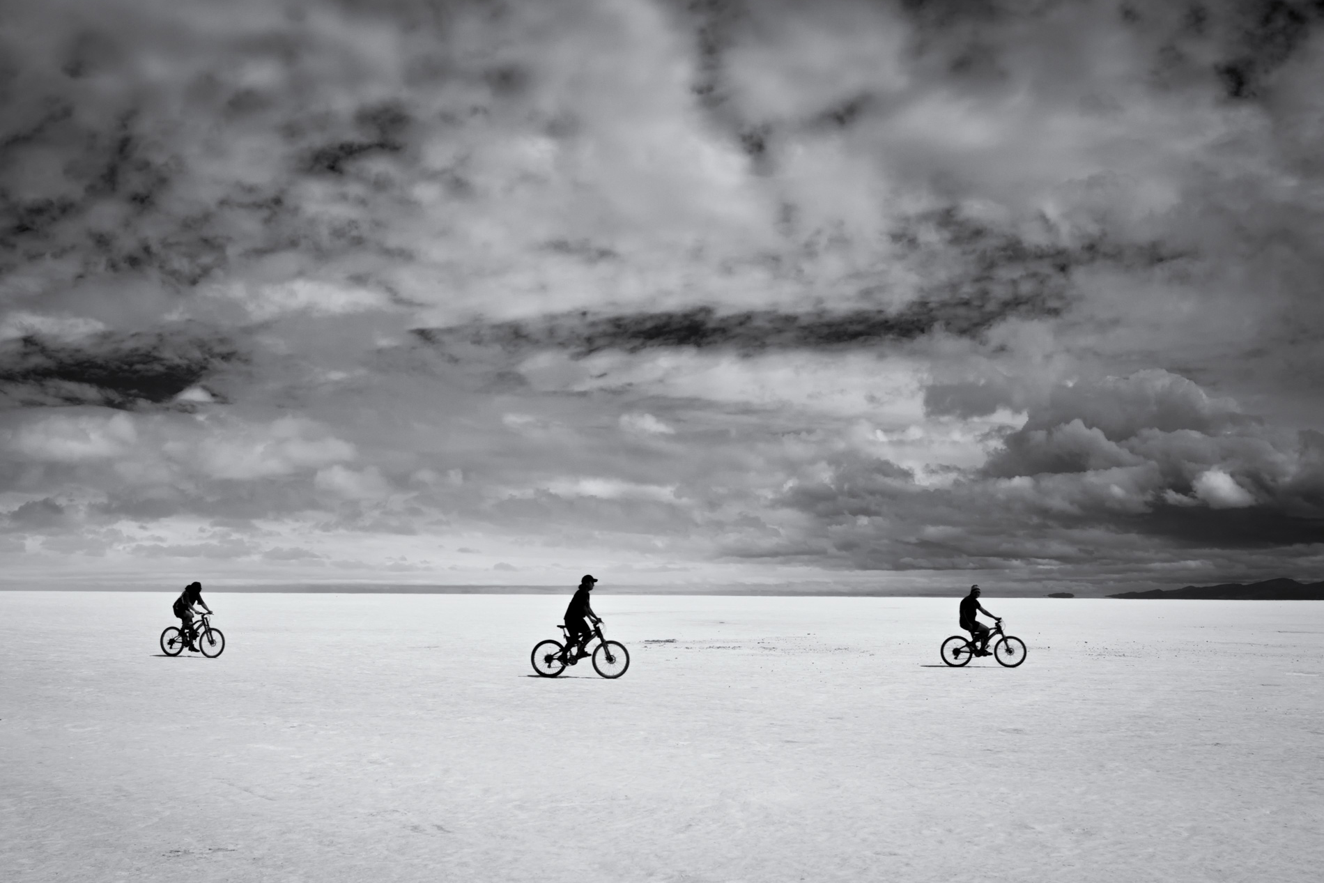 Salar de Uyuni in Bolivia is the biggest salt flat in the world. three friends and their bikes. friends cycling.